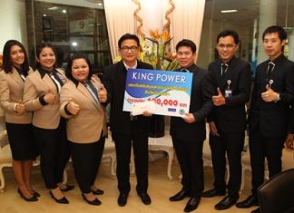 King Power Pattaya Operations Manager Sumitr Wongsamart (center right) presents 10,000 baht to buy 60 sporting outfits for students of Pattaya’s schools to Deputy Mayor Wutisak Rermkitkarn (center left).