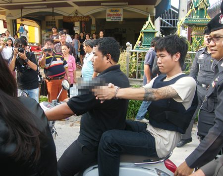 Police brought out Thanachart Chaichana to reenact his shooting of two teenagers after they left an all-night pub in Pattaya.