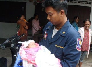 A rescue worker takes the abandoned infant to the hospital for a checkup.