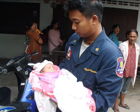 A rescue worker takes the abandoned infant to the hospital for a checkup.