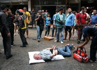 Denis Wieslaw Leszek remains handcuffed on the ground after going into a manic rage on Soi 6.