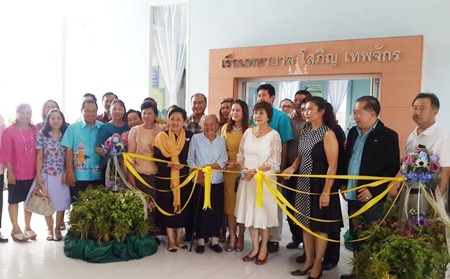Sopin Thappajug (center), executive director of the Diana Group, along with members of area Lions clubs, cuts the ribbon to officially open the new medical center at Pattaya School #7.