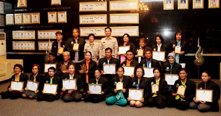 Mayor Itthiphol Kunplome (back row, center) presents awards to Pattaya’s most outstanding citizens and community groups for upholding royal values and working on behalf of society.