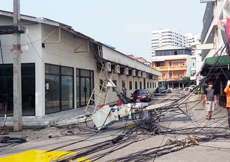 The storm tore down electric posts in Soi Yensabai, knocking out power for hours.