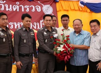 Nongprue Mayor Mai Chaiyanit (2nd right) presents a congratulations basket to Nongprue Police Station Superintendent Col. Suthisak Wanthee on National Police Day.