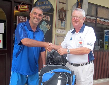 Dick Warberg (right) is presented with the MBMG Group Golfer of the Month award by Mark West.