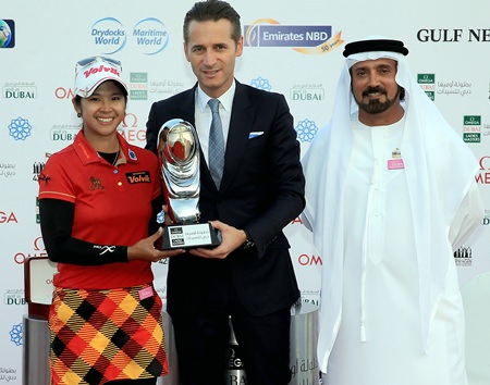 Thailand’s Pornanong Phatlum (left) is shown receiving the 2013 winner’s trophy from Raynald Aeschlimann, vice president, International Sales Director of Omega, as Mohamed Juma Buamaim, vice chairman and CEO of golf in DUBAi, looks on.