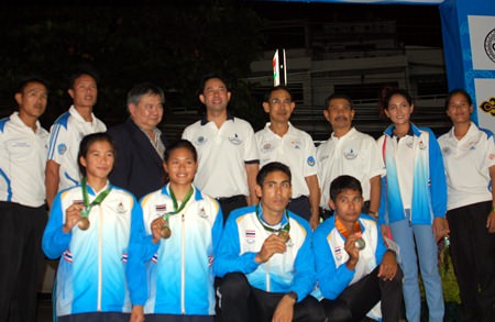 Thailand’s four successful windsurfers display their Asian Games medals as they pose with public officials and TWA representatives at Jomtien Beach, Oct. 19.
