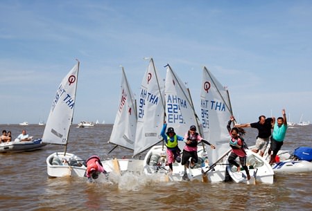 Thai junior sailors leap into the water to celebrate victory in the team sailing event, Sunday, Oct. 26. (Photo/Matias Capizzano)