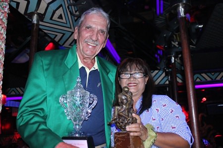 Butch Porter (left) receives the TQ Masters champion’s trophy and Green Jacket from Mamasan Ead.