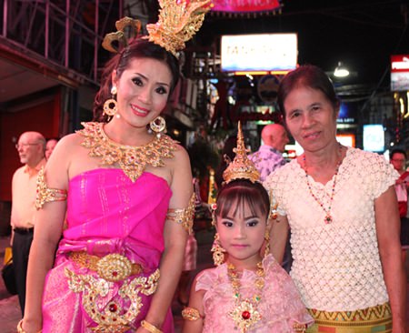 Three generations dress traditionally for the event.