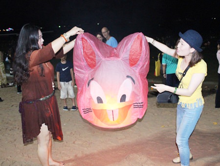 Tourists release a cartoon lantern.