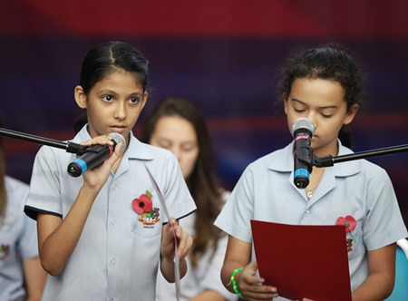 GIS students read out anti-war poetry at a whole school assembly.