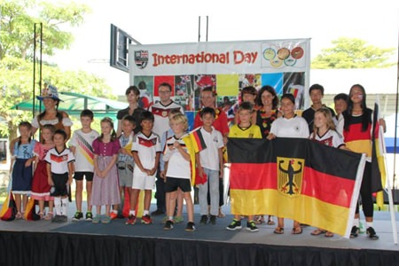 Children representing Germany fly the flag.