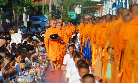 Thais and foreigners line the street in North Pattaya to give alms to monks that will be delivered 323 temples in 4 embattled southern provinces.