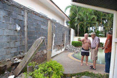 The roofs of a new housing project have been built so close to the boundary, when it rains, large amounts of water pours into the homes of residents in Green Field Villa 2.  The wall the contractor created also fell down.