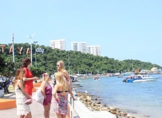 Tourists gather near Bali Hai. Part of the Pratamnak Hill area that officials hope to turn into a huge eco-tourism attraction is seen in the background.