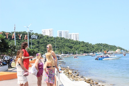 Tourists gather near Bali Hai. Part of the Pratamnak Hill area that officials hope to turn into a huge eco-tourism attraction is seen in the background.