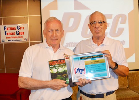 MC Richard Silverberg presents the PCEC’s Certificate of Appreciation to author Tom Crowley while Tom holds up a copy of his latest Matt Chance novel, “Murder in the Slaughterhouse.”