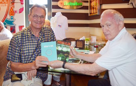 PCEC member John Lynham, organizer of the PCEC’s Writers Group, shows the two books “Vipers Tail” and “Murder in the Slaughterhouse” autographed by author Tom Crowley.
