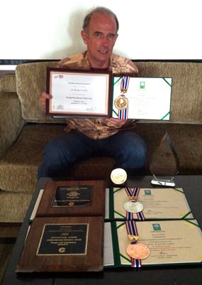 Stuart shows some of his many awards for inventions; including selection for the CES Design and Engineering Exhibition twice, the Award for Engineering Excellence at the 2013 World Metro Summit in Shanghai, and Bronze, Silver & Gold Medals at the recent Thailand Inventors Award.