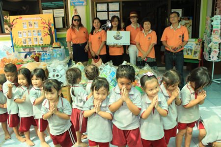 Children at the Father Ray Day Care Center say thank you to members of the Lions Club of Pratamnak for donating rice, food and supplies.