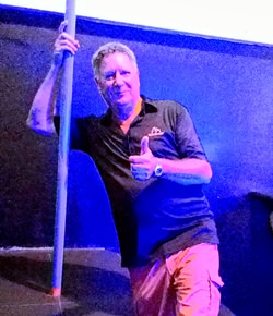 Nev sizes up the dancing pole.