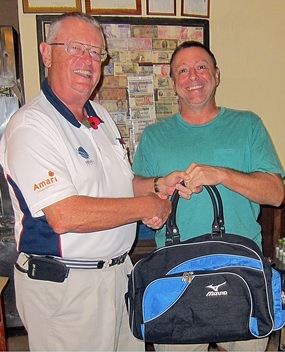 MBMG Group Golfer of the Month Tom Herrington (right) receives his prize from Dick Warberg.