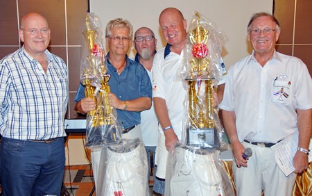 Tournament winners Tore Eliassen and Odd Holm-Hansen receive their prizes from Graham MacDonald MBE (left), President of the Royal British Legion, Emcee Derek Brook (right) and Max Matthews (standing rear centre)