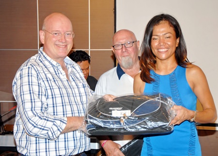 Ning Neal (right) receives a near pin prize from Graham MacDonald.