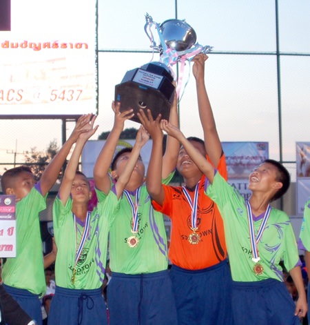 Sabaidee FC players hoist the trophy after winning the 11 years age group category.