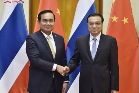 Chinese Premier Li Keqiang (R) shakes hands with visiting Thai Prime Minister Prayuth Chan-ocha before their talks in Beijing, capital of China, Dec. 22, 2014. (Xinhua/Xie Huanchi) 