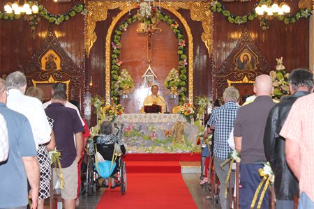 Father Glisada Sukapat, Abbot of St. Nicolaus church, celebrates Christmas Mass with over 300 participants.