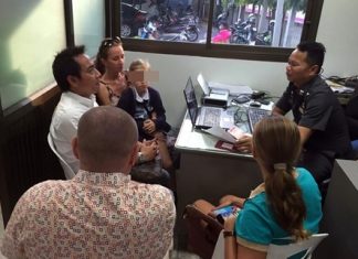 Vladimir Pomytkin and wife Yulia Tikhovskaya make a report to police about Aleksander Kuznetsov who allegedly tried to kidnap Yulia in Pattaya.