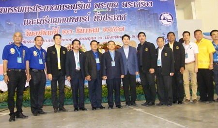 Officials pose for an opening photo at the start of the Pattaya Amulet Association’s show at the Eastern National Indoor Sports Stadium.