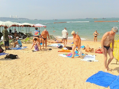 Tourists have begun to reclaim the beach, bringing their own mats and towels to lie on, as shown here at the beach by Central Pattaya t-junction.