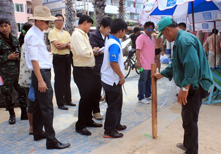 Pattaya and military officials begin staking out new zones for beach chairs and umbrellas on Pattaya Beach.