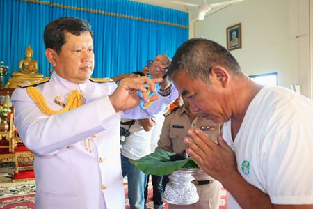 Vice Adm. Viphak Noijinda presides over the head-shaving ceremony for the 74 monks-to-be, who will be ordained Dec. 5 at Khao Bamphenbun Temple in Najomtien.