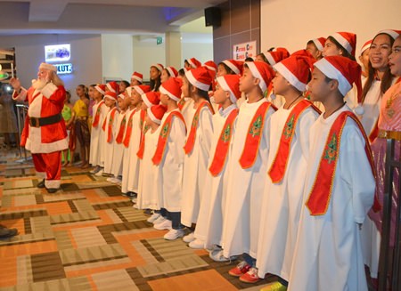 Santa makes his appearance to the delight of the children and starts leading them in some more Christmas Carols.