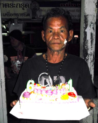 Boonlua prepares to share his birthday cake with friends from the Pattaya Amulets Club.