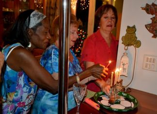 Guests bond together to light one of the menorah candles