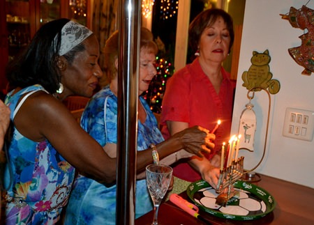 Guests bond together to light one of the menorah candles