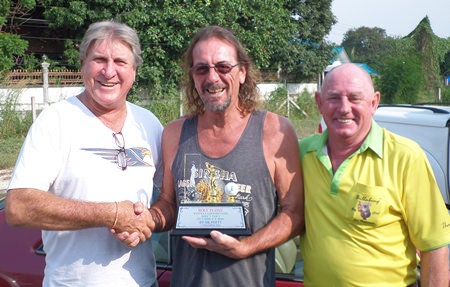 Pottsy (centre) had a hole in one earlier in November at Pattaya Country Club. Here he receives a commemorative trophy from Rosco (left) and Capt. Bob.