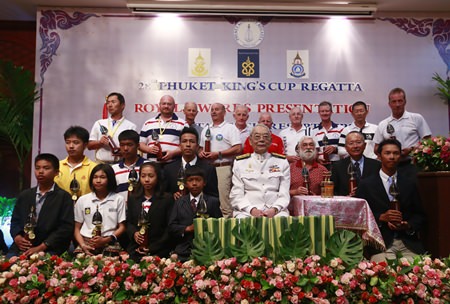 His Excellency Admiral M.L. Usni Pramoj, His Majesty the King’s Personal Representative (centre), poses with individual champions and winning teams during the trophy presentation at this year’s Phuket King’s Cup Regatta.