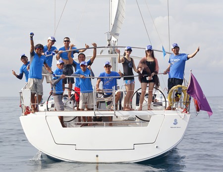 The crew on H-Trip give the thumbs up between races.