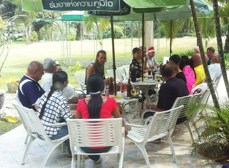 Caddies and players join together for food & drink on the terrace of the Pattaya Country Club clubhouse.