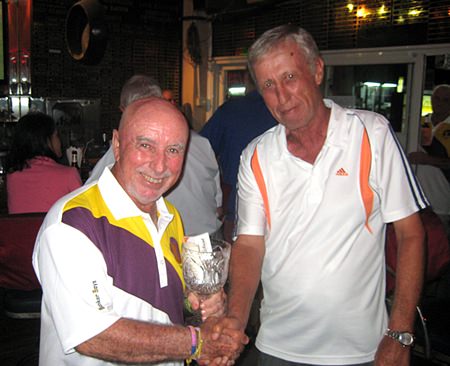 Geoff Parker (right) presents the men’s individual trophy to Sugar Ray Handford.