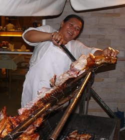 Thai Garden Resort chef merrily cutting away at the roast pig.