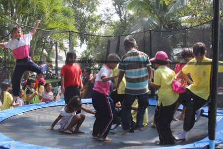 Children enjoy themselves at the trampoline cage in Nongprue.