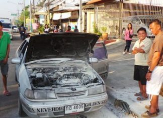 Faulty repair blamed for car fire Singhnart Wattanasri (front, right) looks over his burnt out car as others try to console him.